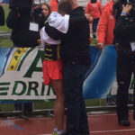 Race director Cees Pronk comforts the exhausted and heartbroken Butter after the athlete just missed qualifying for Rio